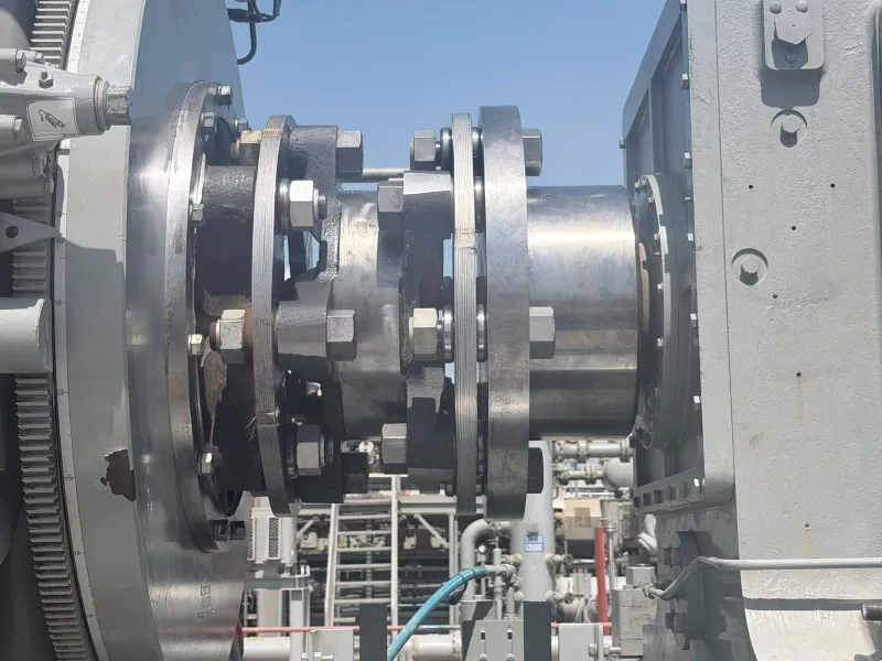 Coupling between gas engine flywheel and compressor frame