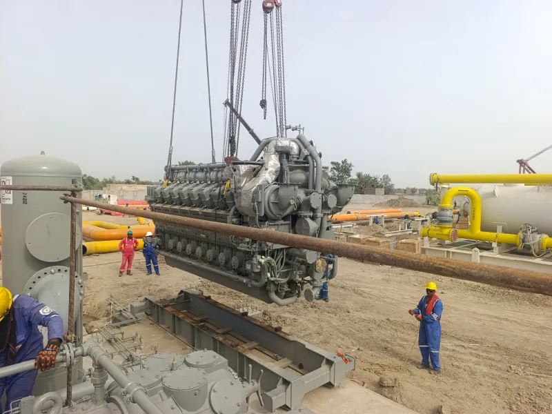 Gas engine lifted by crane onto a compressor package